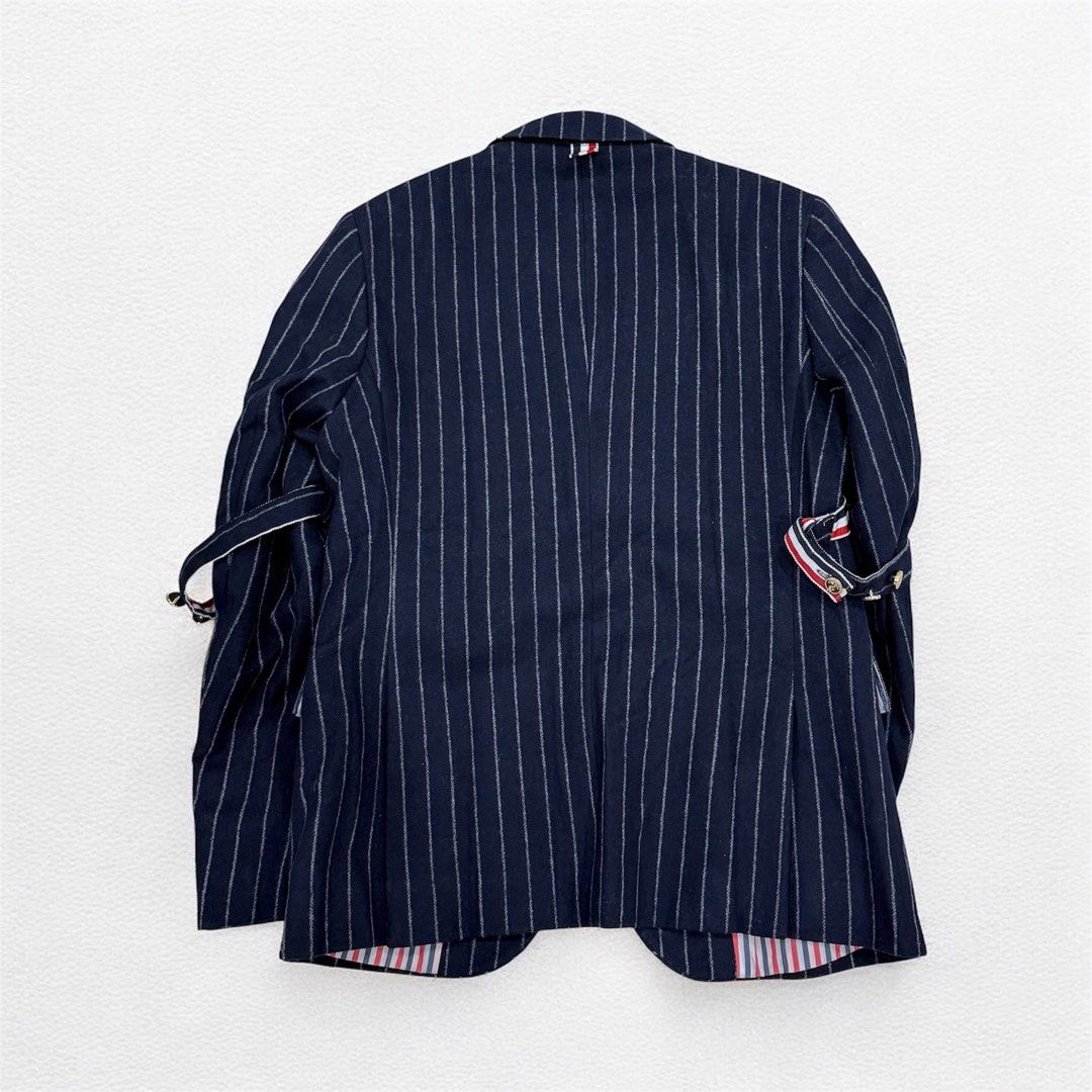 Thom Browne navy blue chalk-stripe blazer (Category: Activewear) located in Manila. Submitted by mankindarchivesv2 (Listing ID 1470692254, Image 3). Description: Thom Browne navy blue chalk-stripe blazer featuring signature sleeve armbands, gold-tone buttons, and striped lining Size: 2 Excellent condition / No hidden issue Price: 6000 php Mode of payment G cash Bank Courier Jnt lalamove Pm me if interested .