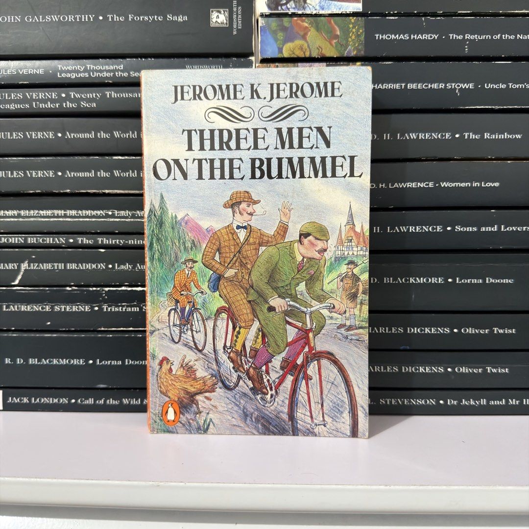 Three Men on the Bummel by Jerome K. Jerome (Category: Storybooks) located in Lingayen. Submitted by readwjane (Listing ID 1470704640, Image 1). Description: - Title: Three Men on the Bummel by Jerome K. Jerome - Edition: Penguin paperback with illustrated cover - Condition: Minor shelf wear on spine and cover; pages are fully intact - Genre: Classic British travel comedy and humor - Ideal for: Book collectors and fans of witty literature.