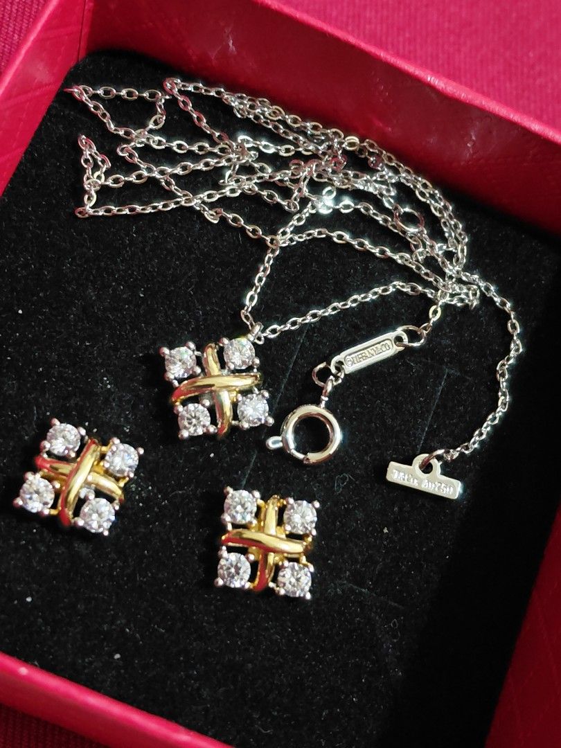 Tiffany&Co Set (Category: Earrings) located in Guiguinto. Submitted by blader2980 (Listing ID 1470685914, Image 1). Description: - T&Co. Au750 - Complete jewelry set including necklace and matching stud earrings - Elegant HK jewelry design featuring a gold and silver tone cross-accent with sparkling stones - Perfect accessory for casual days, parties, and special events - Authenticity not guaranteed and items are untested - Beautiful addition to 