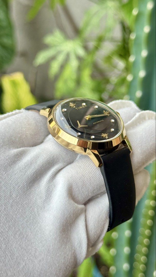 Timex Automatic Watch Gold Black Star Dial (Category: Luxury Watches) located in Manila. Submitted by junjun12356 (Listing ID 1470558443, Image 3). Description: - Brand: Timex - Movement: Automatic - Case: Gold-tone with a domed crystal - Dial: Black with star and crystal hour markers, and gold hands - Strap: Black textured leather strap - Condition: Clean overall with minimal signs of wear.