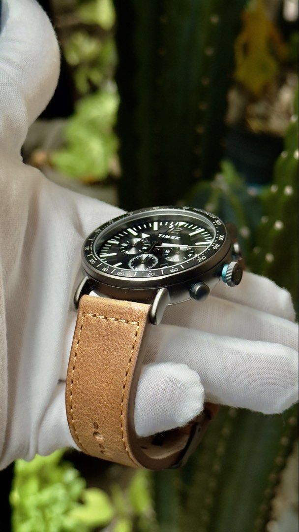 Timex Chronograph Watch with Leather Strap (Category: Men's Watches) located in Manila. Submitted by junjun12356 (Listing ID 1470557898, Image 2). Description: Timex chronograph watch featuring a dark grey dial and tachymeter bezel. Brown leather strap with contrast stitching and buckle closure. Sub-dials track minutes and seconds, plus a date window at the four o'clock position. White hands and hour markers stand out clearly against the face. Ma