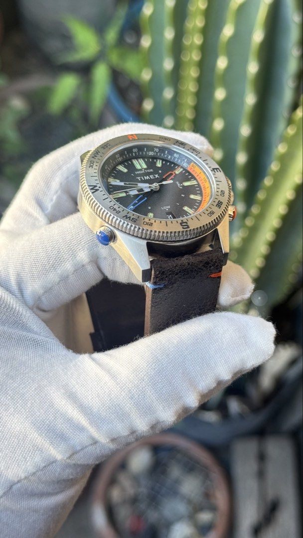 Timex Tide Temperature Compass Watch (Category: Men's Watches) located in Manila. Submitted by junjun12356 (Listing ID 1470702415, Image 3). Description: - Brand: Timex - Model: Tide Temperature Compass - Material: Stainless steel case with dark brown leather strap (featuring cool blue and orange accent stitching) - Dial: Textured black dial with date window at 6 o'clock and Indiglo night-light - Bezel: Rotational compass bezel with cardinal dire