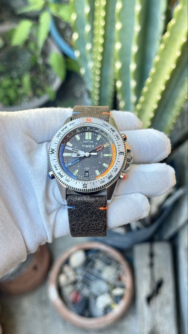 Timex Tide Temperature Compass Watch (Category: Men's Watches) located in Manila. Submitted by junjun12356 (Listing ID 1470702415, Image 2). Description: - Brand: Timex - Model: Tide Temperature Compass - Material: Stainless steel case with dark brown leather strap (featuring cool blue and orange accent stitching) - Dial: Textured black dial with date window at 6 o'clock and Indiglo night-light - Bezel: Rotational compass bezel with cardinal dire