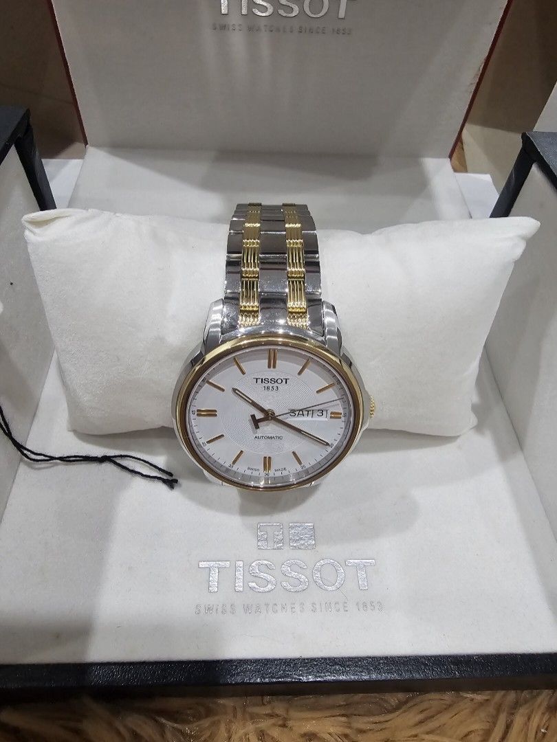 Tissot 1853 Automatic Two-Tone Watch with Box (Category: Luxury Watches) located in Bulacan. Submitted by ms.gemini (Listing ID 1470687824, Image 1). Description: - Brand: Tissot 1853 - Movement: Automatic - Design: Two-tone steel and gold bracelet with silver textured dial - Features: Day and date window at 3 o'clock - Inclusion: Original branded presentation boxes and packaging - Condition: Classic Swiss timepiece, ready to wear or gift Mall pr
