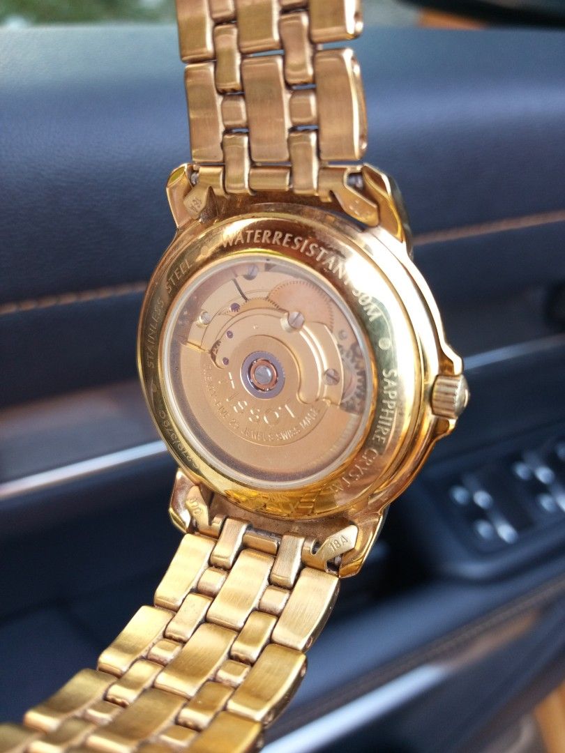 Tissot Ballade Automatic Gold Tone Watch (Category: Luxury Watches) located in Malolos. Submitted by lizarondoe59660 (Listing ID 1470679306, Image 3). Description: - Brand: Tissot Ballade Automatic - Finish: Elegant gold-tone stainless steel (case and matching link bracelet) - Dial: Champagne with classic Roman numerals and 3 o'clock date window - Crystal & Caseback: Sapphire crystal with exhibition display back showing the 25-jewel movement - Cl