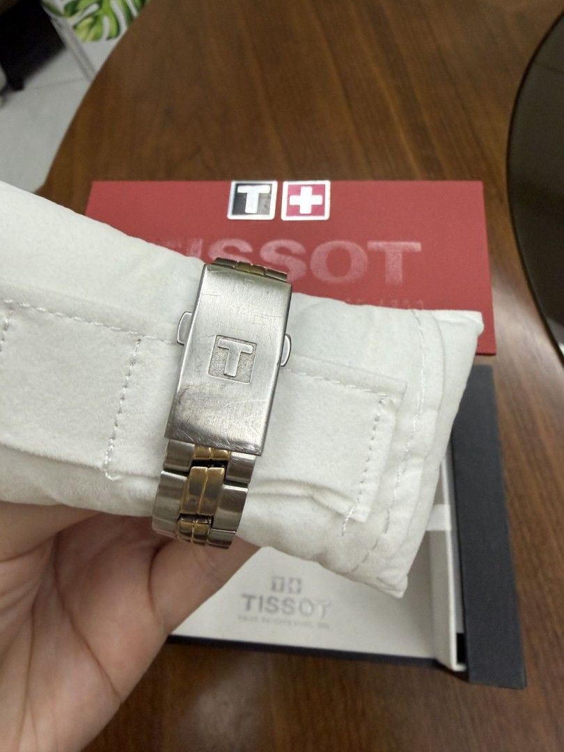 Tissot PR 100 Two-Tone Watch with Box (Category: Luxury Watches) located in Manila. Submitted by anythingbyjen (Listing ID 1470607691, Image 3). Description: - Authentic Tissot PR 100 wristwatch - Two-tone stainless steel and gold finish - Classic white dial with gold hands, index markers, and 6 o'clock date window - Secure folding clasp closure with iconic T logo - Includes original red and black Tissot presentation box - Condition: Shows visibl