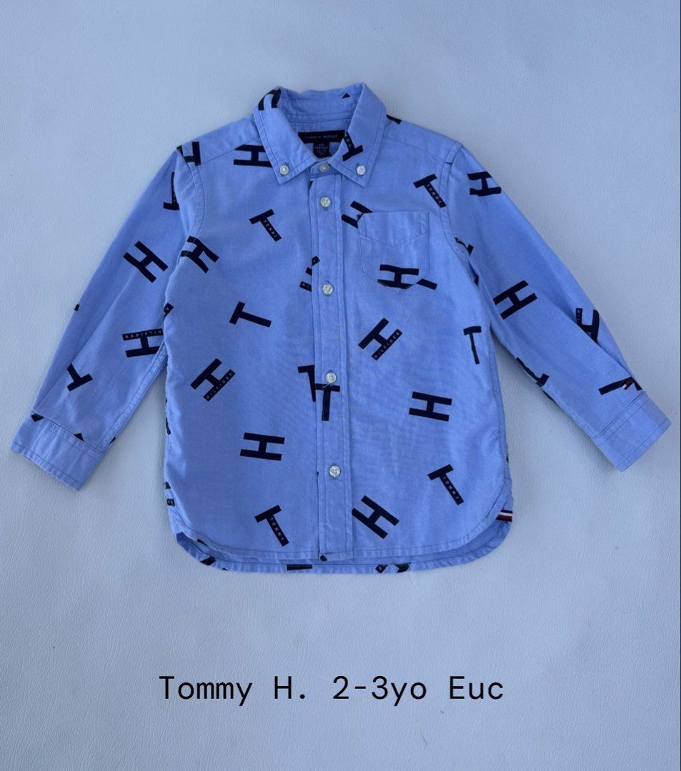 Tommy Hilfiger Monogram Button-Down Shirt (Category: Babies & Kids Fashion) located in Pozorrubio. Submitted by izaykite2g (Listing ID 1470684219, Image 1). Description: - Brand: Tommy Hilfiger - Size: Toddler - Design: Light blue with all-over black monogram print - Details: Long sleeves, classic collar, front chest pocket, and branded buttons - Closure: Front button-down - Condition: Clean, well-cared-for, and excellent pre-loved condition.