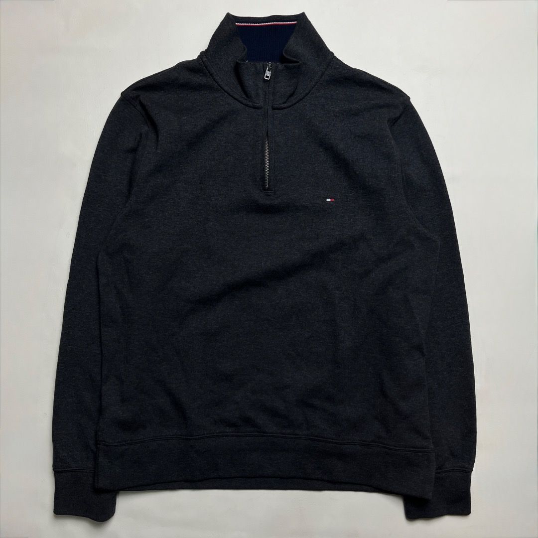 Tommy Hilfiger Q-Zip Dark Grey Sweater (Category: Coats, Jackets and Outerwear) located in Caloocan City. Submitted by achilles_grails (Listing ID 1470593424, Image 1). Description: - Brand: Tommy Hilfiger - Style: Quarter zip sweatshirt - Color: Dark grey heather with navy/red/white collar tipping - Size: L - Material: 73% cotton, 27% polyester (Made in India) - Details: Branded metal zipper pull and small embroidered chest logo - Condition: Cle