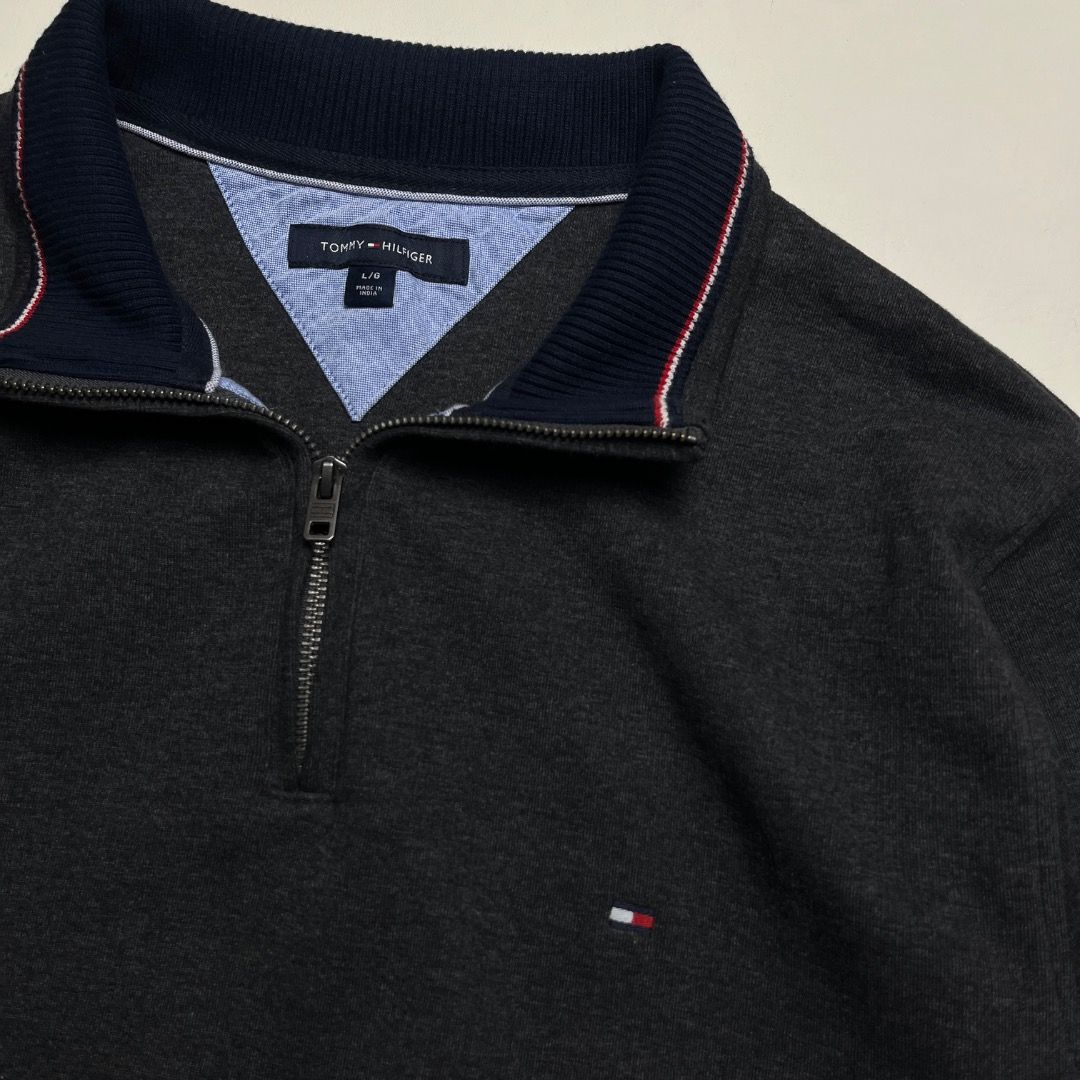 Tommy Hilfiger Q-Zip Dark Grey Sweater (Category: Coats, Jackets and Outerwear) located in Caloocan City. Submitted by achilles_grails (Listing ID 1470593424, Image 2). Description: - Brand: Tommy Hilfiger - Style: Quarter zip sweatshirt - Color: Dark grey heather with navy/red/white collar tipping - Size: L - Material: 73% cotton, 27% polyester (Made in India) - Details: Branded metal zipper pull and small embroidered chest logo - Condition: Cle