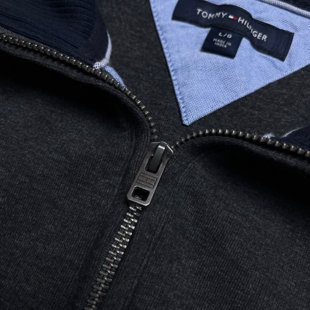 Tommy Hilfiger Q-Zip Dark Grey Sweater (Category: Coats, Jackets and Outerwear) located in Caloocan City. Submitted by achilles_grails (Listing ID 1470593424, Image 3). Description: - Brand: Tommy Hilfiger - Style: Quarter zip sweatshirt - Color: Dark grey heather with navy/red/white collar tipping - Size: L - Material: 73% cotton, 27% polyester (Made in India) - Details: Branded metal zipper pull and small embroidered chest logo - Condition: Cle