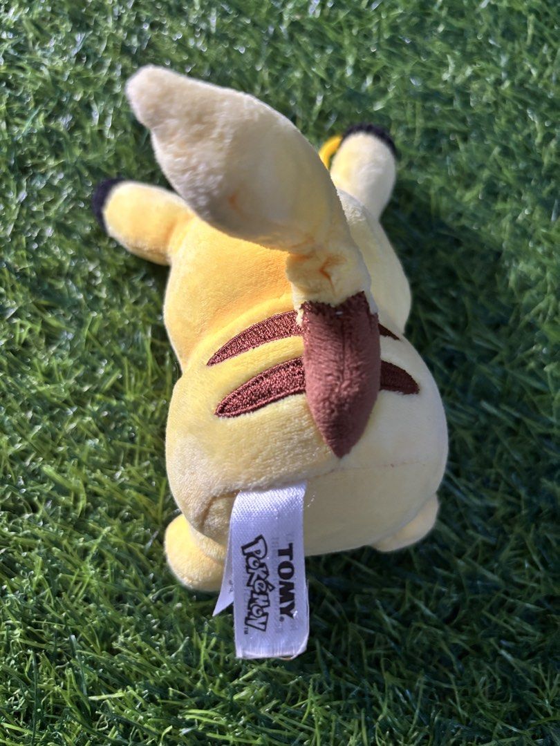 TOMY Pokémon Pikachu Plush Toy (Category: Plushies & Soft Toys) located in Makati City. Submitted by rare_thrift_stuff (Listing ID 1470612480, Image 2). Description: - Official TOMY Pokémon Pikachu plush - Bright yellow body with embroidered facial features and classic red cheeks - Features brown stripes on the back and black-tipped ears - Attached TOMY tag intact with registration details and CE mark - Clean fabric overall, great for collectors 
