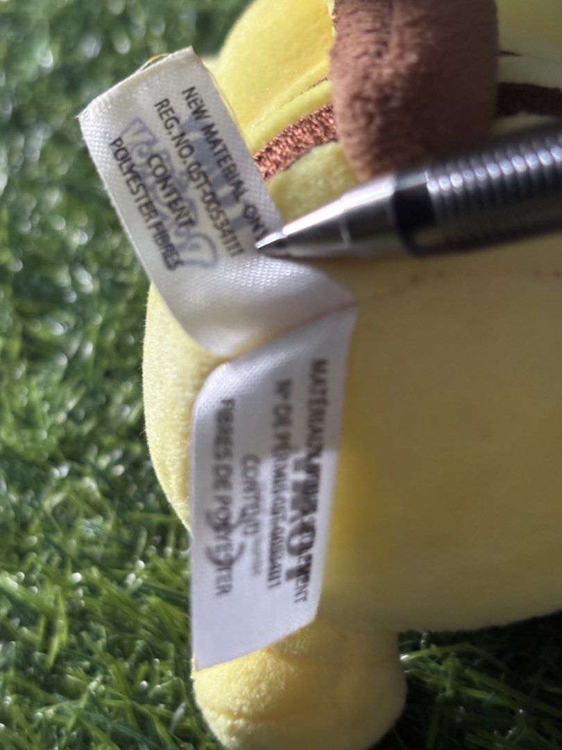 TOMY Pokémon Pikachu Plush Toy (Category: Plushies & Soft Toys) located in Makati City. Submitted by rare_thrift_stuff (Listing ID 1470612480, Image 3). Description: - Official TOMY Pokémon Pikachu plush - Bright yellow body with embroidered facial features and classic red cheeks - Features brown stripes on the back and black-tipped ears - Attached TOMY tag intact with registration details and CE mark - Clean fabric overall, great for collectors 
