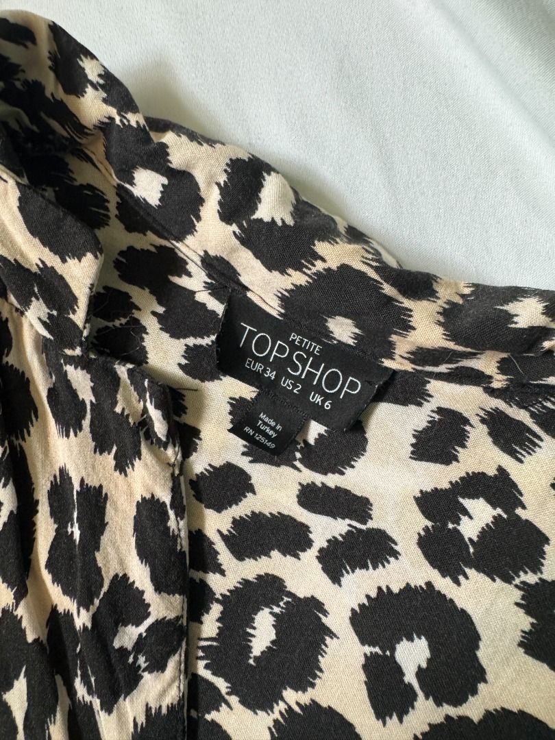 Topshop Petite Leopard Print Button Down Blouse Size UK 6 (Category: Blouses) located in Cebu City. Submitted by _t.rix (Listing ID 1470573273, Image 3). Description: - Brand: Topshop Petite - Pattern: All-over black and cream leopard print - Size: US 2, UK 6, EUR 34 - Fit: Relaxed fit with a notched lapel collar - Details: Long sleeves with button cuffs - Origin: Made in Turkey - Condition: Excellent / Ready to wear.