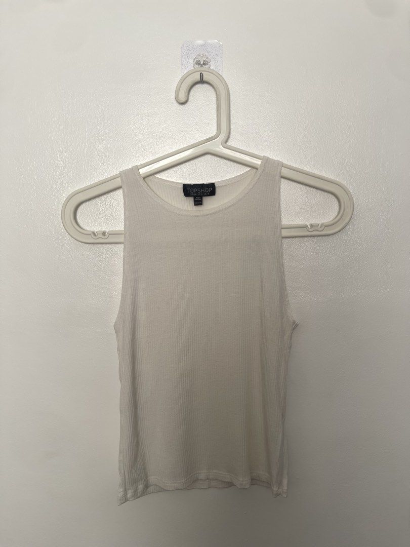 Topshop White Ribbed Tank Top (Category: Sleeveless) located in Manila. Submitted by lovedbymidge (Listing ID 1470638562, Image 1). Description: 🩷 for xs-s girlies 🚚 lalamove or grab express (sf shouldered by the buyer!) - Brand: Topshop - Color: White - Size: UK 8 / US 4 / EUR 36 - Fit: Fitted, stretchy, and comfortable - Neckline: Classic scoop neck - Condition: Clean and ready to wear - Styling: Perfect to pair with jeans, skirts, or shorts.