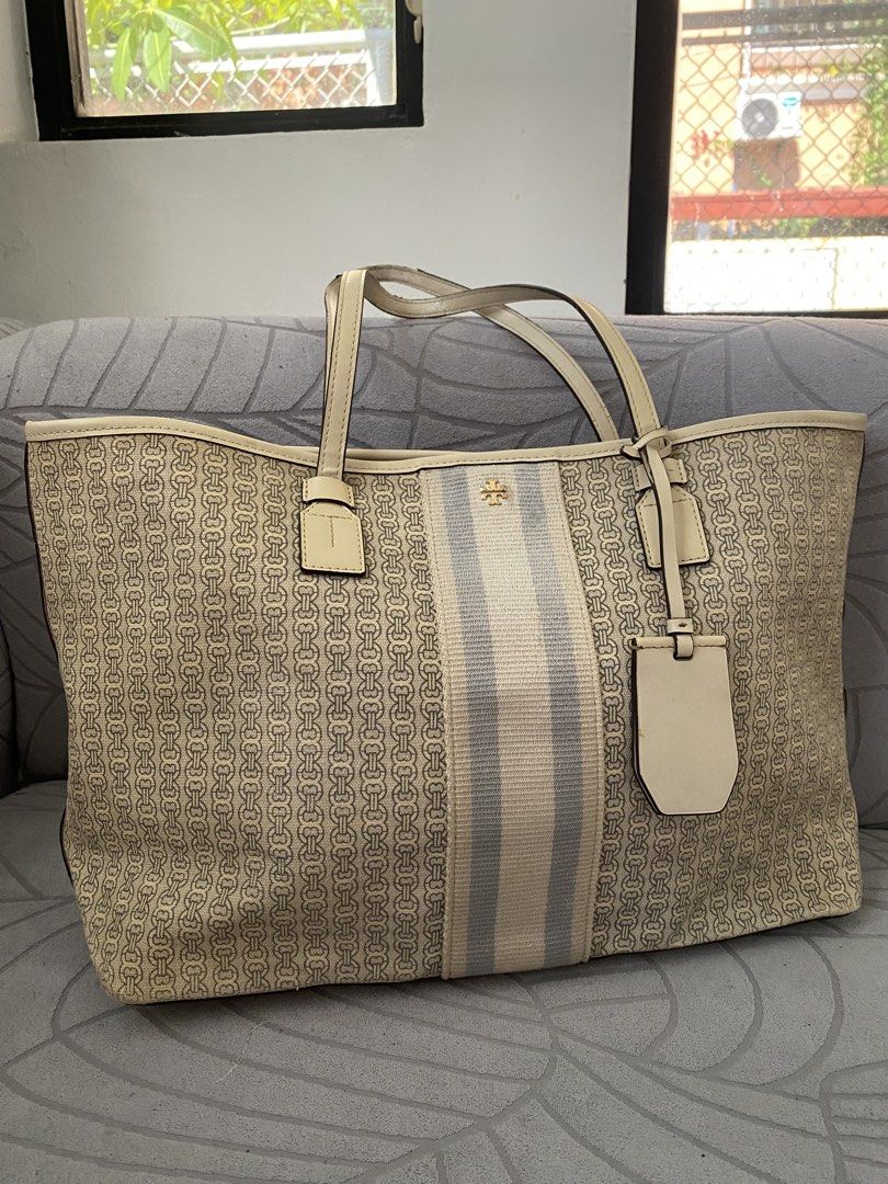 Tory Burch Beige Patterned Tote Bag (Category: Tote Bags) located in Calapan. Submitted by kimmieartsycraft (Listing ID 1470625580, Image 3). Description: - Brand: Tory Burch - Design: Cream and beige geometric chain pattern with an off-white and grey center stripe - Hardware: Gold-tone logo accent - Straps: Dual leather shoulder straps - Extras: Matching hanging luggage tag charm - Interior: Spacious, perfect for daily essentials - Style: Neutra