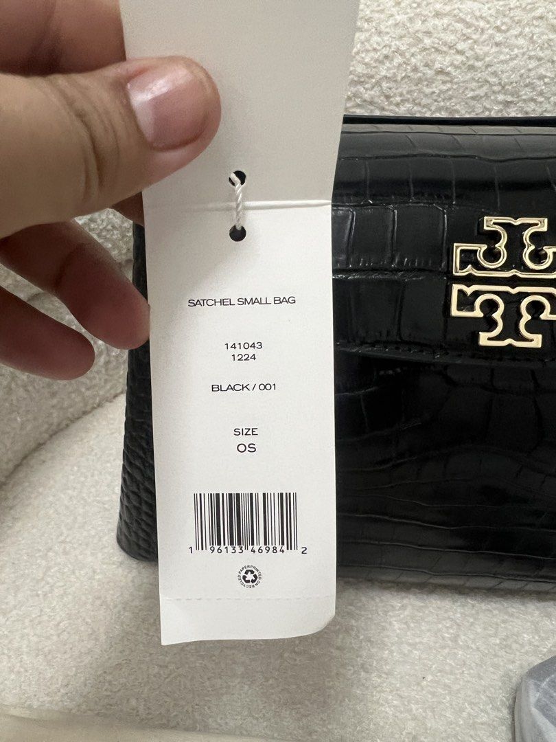 Tory Burch Black Croc Embossed Satchel Bag (Category: Shoulder Bags) located in Abulug. Submitted by jamiecammie (Listing ID 1470593690, Image 2). Description: - Authentic Tory Burch small satchel in black croc-embossed leather - Elegant gold-tone hardware with iconic front flap logo clasp - Brand new with original store tag attached (Style No: 141043) - Features a structured top handle and protective metal feet on the bottom - Includes a removab