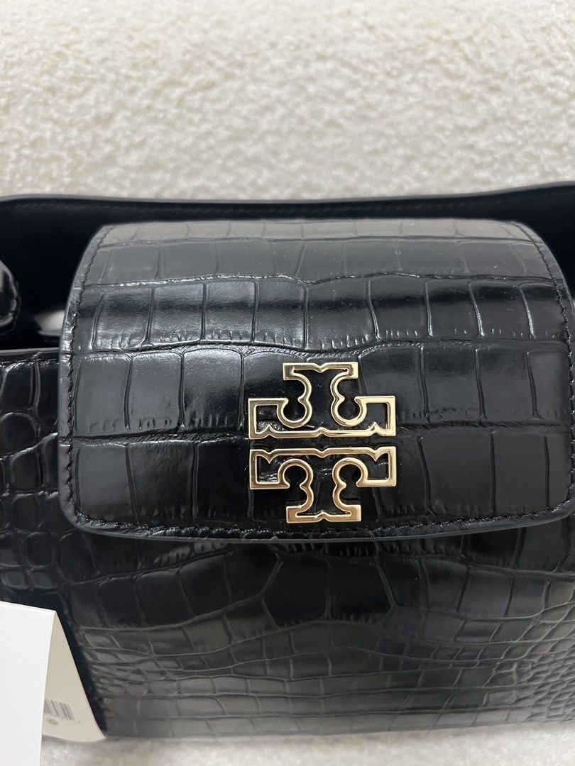 Tory Burch Black Croc Embossed Satchel Bag (Category: Shoulder Bags) located in Abulug. Submitted by jamiecammie (Listing ID 1470593690, Image 3). Description: - Authentic Tory Burch small satchel in black croc-embossed leather - Elegant gold-tone hardware with iconic front flap logo clasp - Brand new with original store tag attached (Style No: 141043) - Features a structured top handle and protective metal feet on the bottom - Includes a removab