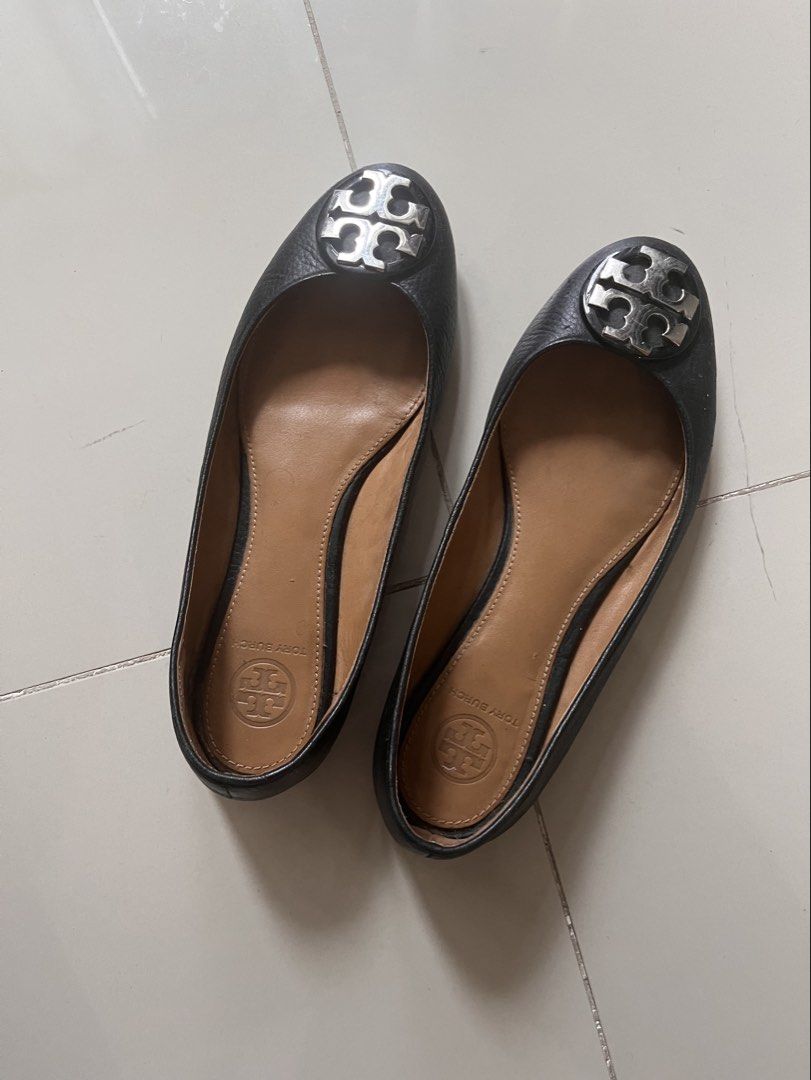 Tory Burch Black Leather Flats Size 6 (Category: Flats & Sandals) located in Quezon City. Submitted by blesshie_ (Listing ID 1470587309, Image 1). Description: - Brand: Tory Burch - Color: Classic black leather with tan insoles - Details: Signature silver hardware logo on rounded toes, slip-on style - Condition: Pre-loved with visible wear on the bottom tread and scuffs on the front edges; sole needs to be sewed again - Perfect for everyday casua