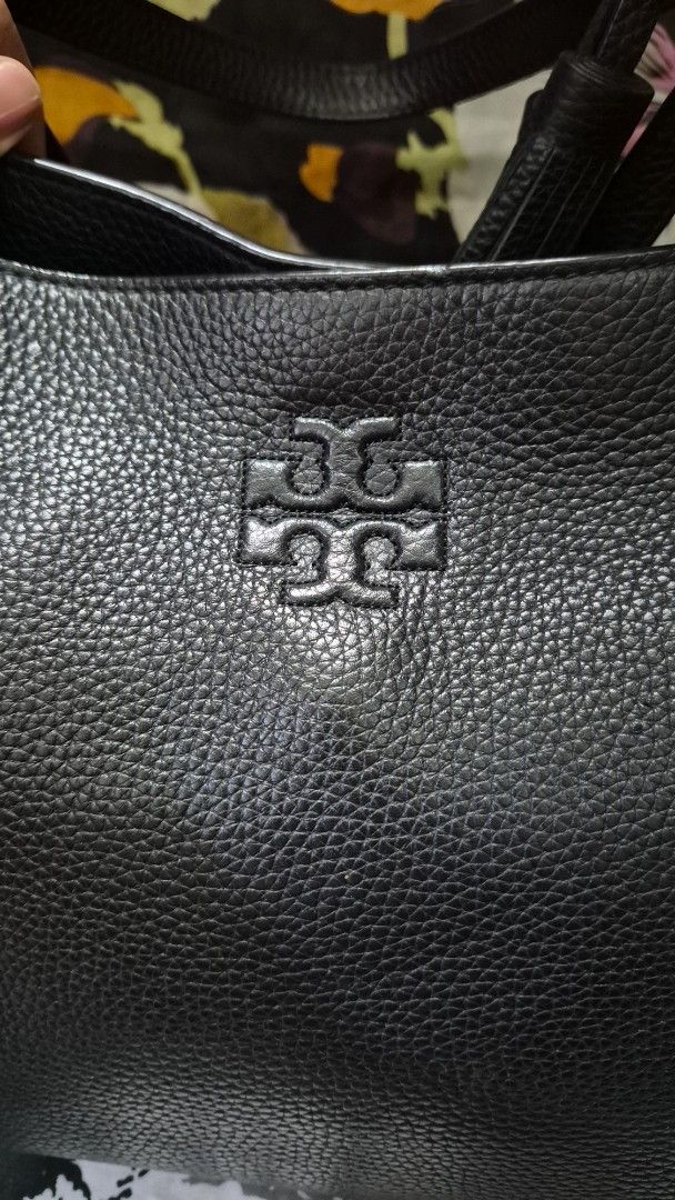 Tory Burch Black Leather Tote Handbag (Category: Looking For) located in Baguio. Submitted by jhaz_bags (Listing ID 1470681830, Image 2). Description: - Authentic Tory Burch tote in classic black pebbled leather - Features double shoulder straps and chic matching leather side tassels - Iconic embossed double T logo on the front - Structured bottom base helps the bag keep its shape - Spacious interior easily fits all your daily essentials - Shippi