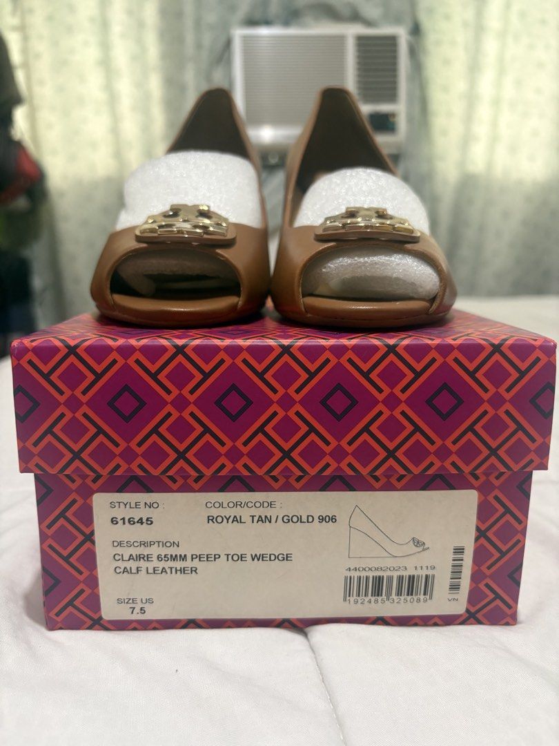 Tory Burch Claire 65mm Peep Toe Wedge Royal Tan (Category: Wedges) located in Manila. Submitted by nykji96 (Listing ID 1470698317, Image 2). Description: Tory Burch Claire peep toe wedge in royal tan calf leather with gold hardware. Style number 61645. Size US 7.5. Heel height 65mm. Wood-grain wedge heel. Original branded box included with stuffing paper inside shoes..
