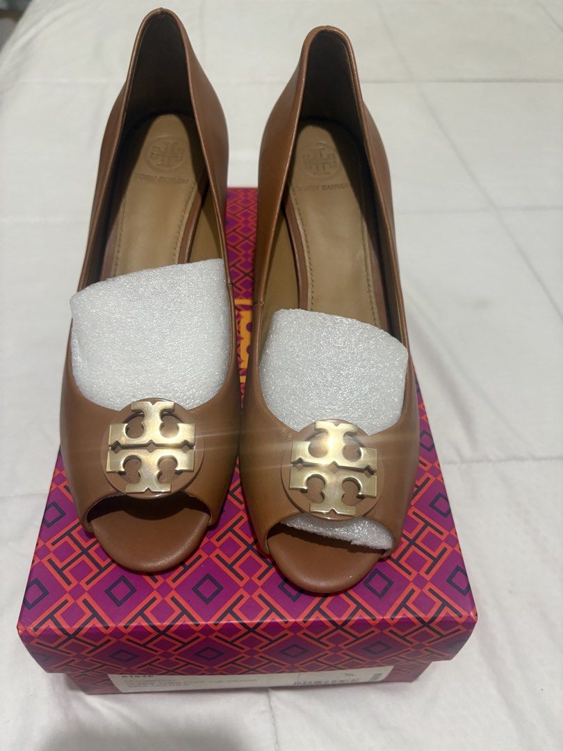 Tory Burch Claire 65mm Peep Toe Wedge Royal Tan (Category: Wedges) located in Manila. Submitted by nykji96 (Listing ID 1470698317, Image 1). Description: Tory Burch Claire peep toe wedge in royal tan calf leather with gold hardware. Style number 61645. Size US 7.5. Heel height 65mm. Wood-grain wedge heel. Original branded box included with stuffing paper inside shoes..