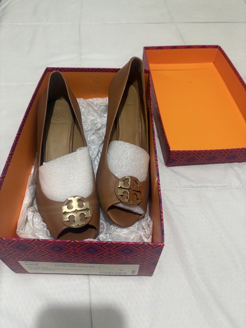 Tory Burch Claire 65mm Peep Toe Wedge Royal Tan (Category: Wedges) located in Manila. Submitted by nykji96 (Listing ID 1470698317, Image 3). Description: Tory Burch Claire peep toe wedge in royal tan calf leather with gold hardware. Style number 61645. Size US 7.5. Heel height 65mm. Wood-grain wedge heel. Original branded box included with stuffing paper inside shoes..