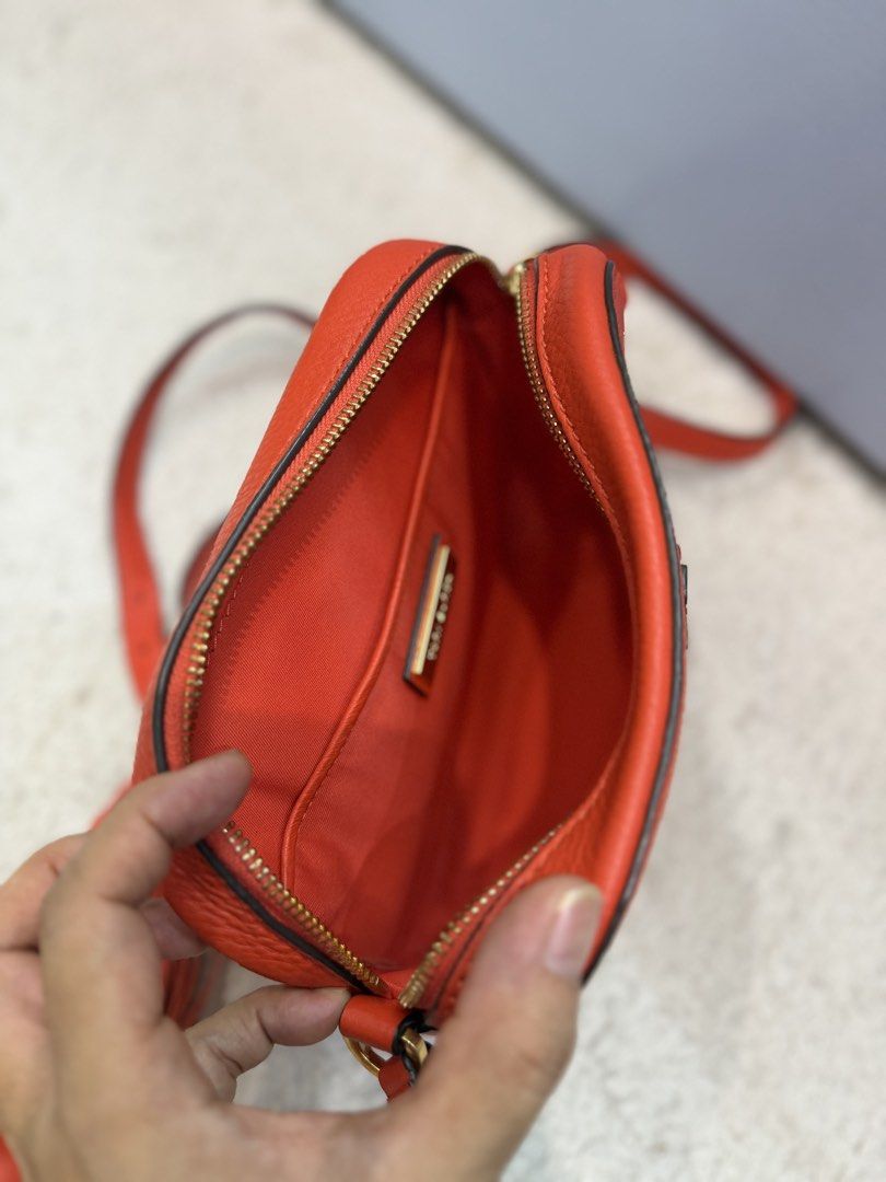 Tory Burch Crossbody bag (Category: Cross-body Bags) located in Rizal. Submitted by myleb.finds (Listing ID 1470592905, Image 2). Description: 🧡 **BOLD COLOR. TIMELESS STYLE.** 👜 Looking for a bag that adds instant character to your outfit? This gorgeous red-orange T😍ry Burch crossbody is a standout piece! ❤️✨ Featuring its signature double-T logo, textured finish, and stylish tassel detail, this beauty is perfect for those who love a little c