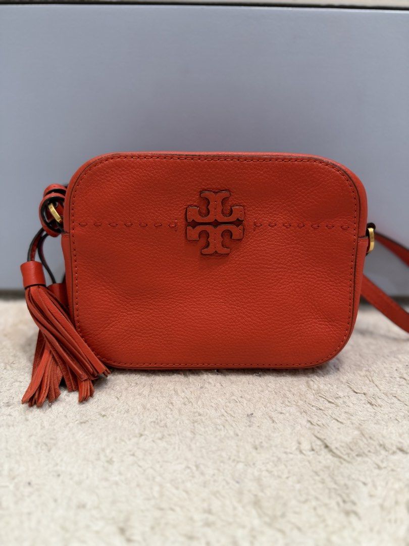 Tory Burch Crossbody bag (Category: Cross-body Bags) located in Rizal. Submitted by myleb.finds (Listing ID 1470592905, Image 1). Description: 🧡 **BOLD COLOR. TIMELESS STYLE.** 👜 Looking for a bag that adds instant character to your outfit? This gorgeous red-orange T😍ry Burch crossbody is a standout piece! ❤️✨ Featuring its signature double-T logo, textured finish, and stylish tassel detail, this beauty is perfect for those who love a little c
