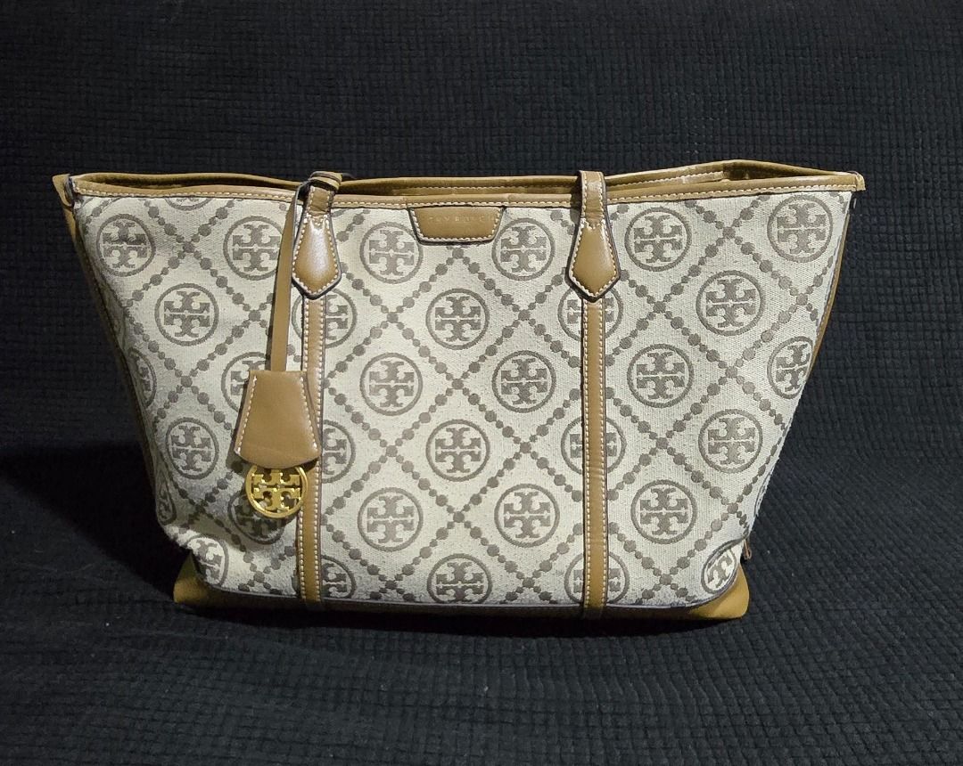 Tory Burch Monogram Tote Bag - Negotiable!!! (Category: Tote Bags) located in Manila. Submitted by axelyuna.27 (Listing ID 1470586201, Image 1). Description: Authentic Tory Burch tote in beige and brown canvas with tan leather trim. Features a structured base, gold-tone logo charm, and clean exterior. Interior shows normal signs of use and discoloration. Perfect everyday bag with classic monogram style!.