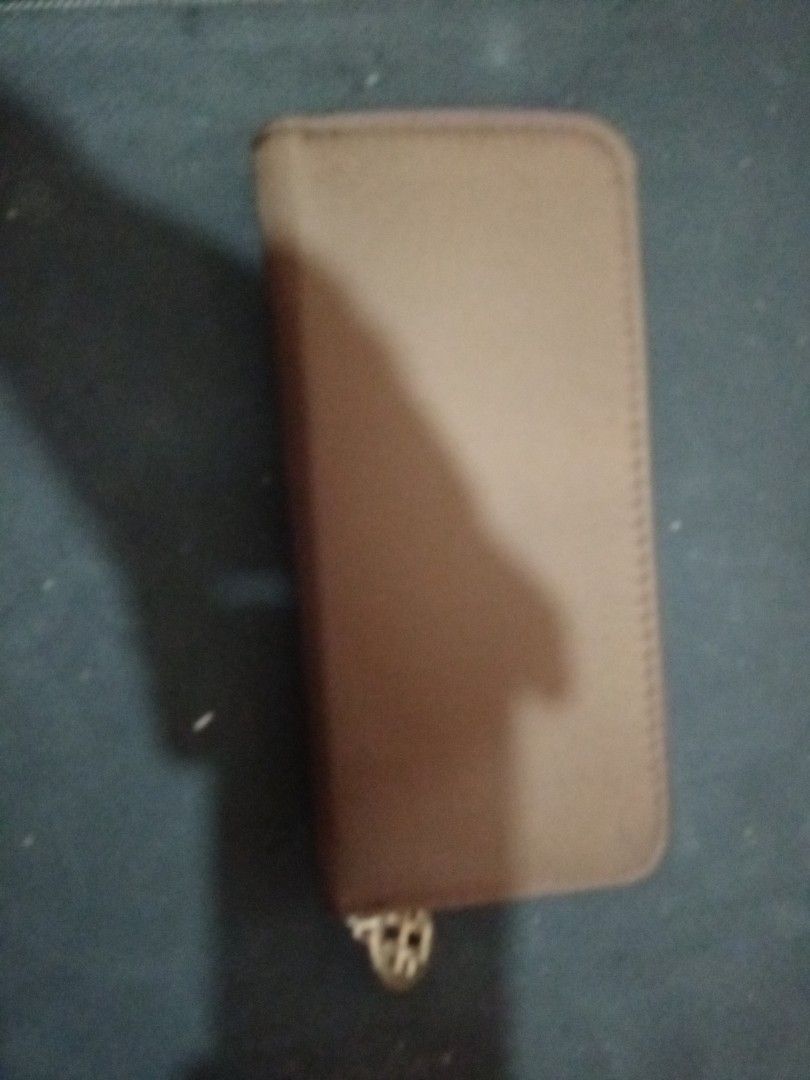 Tory Burch Zip Around Long Wallet Brown (Category: Wallets & Card holders) located in Manila. Submitted by luckyeagle-7ff8 (Listing ID 1470590431, Image 3). Description: - Brand: Tory Burch - Color: Brown with light brown circular T logo - Hardware: Gold-tone with engraved logo zipper pull - Closure: Zip-around - Interior: Multiple compartments and zipped coin pocket for cash and cards - Condition: Well-maintained and 100% authentic.