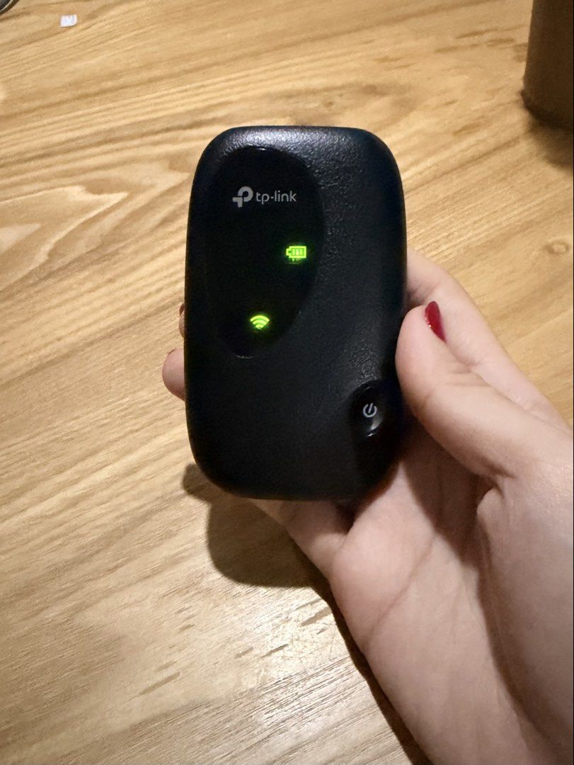 TP-Link Mobile Wi-Fi Hotspot (Category: Networking) located in Cebu City. Submitted by declutteringduo007 (Listing ID 1470617607, Image 3). Description: - Brand: TP-Link portable wireless router - Color/Finish: Sleek black with a textured grip - Design: Compact, palm-sized build with a convenient front power button - Indicators: Dual green status lights for battery and Wi-Fi signal - Use Case: Ideal for travel, commute, and reliable on-the-go int