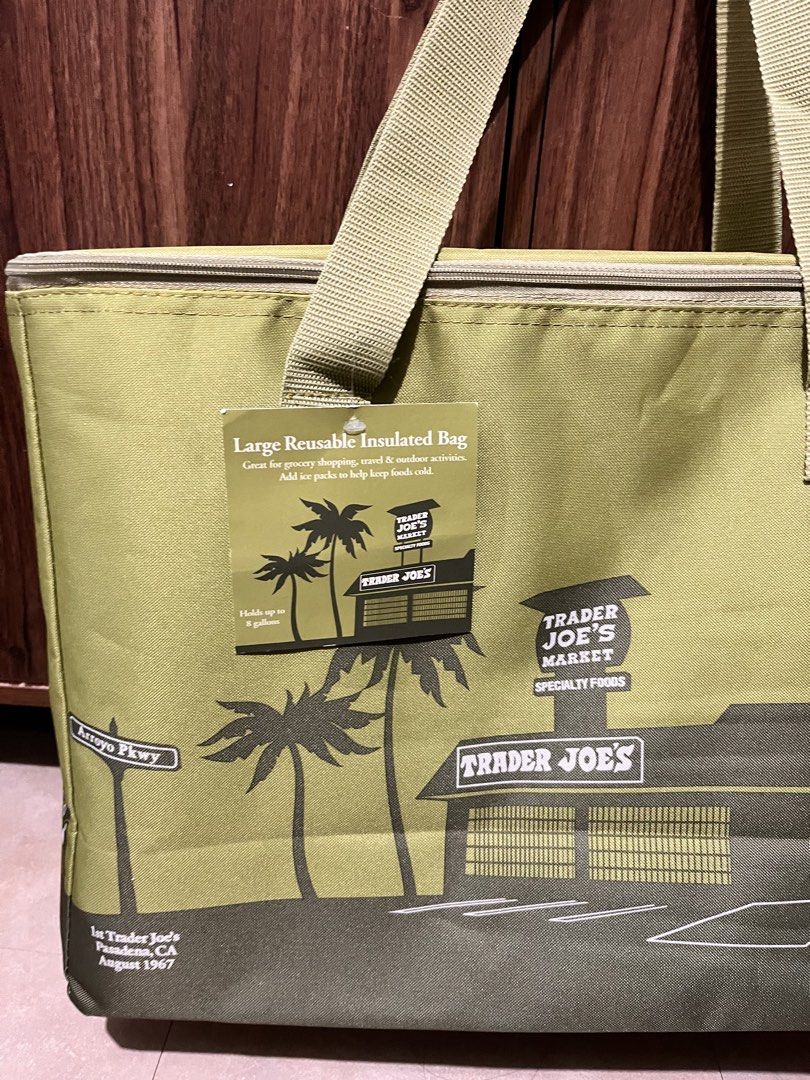Trader Joe's Large Reusable Insulated Bag (Category: Tote Bags) located in Binan City. Submitted by toddnguyen_ (Listing ID 1470646361, Image 2). Description: - Authentic Trader Joe's insulated grocery bag - Color: Stylish olive green with vintage store and palm tree graphic, Pasadena California - Capacity: Large 8-gallon volume for groceries or travel - Condition: Brand new with tag still attached .