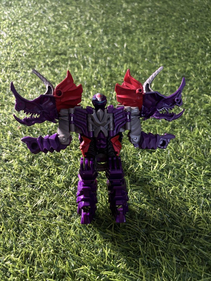 Transformers Dinobot Slug Action Figure Purple (Category: Action & Battle Toys) located in Makati City. Submitted by rare_thrift_stuff (Listing ID 1470612428, Image 1). Description: - Type: Transformers action figure - Mode: Transforms between robot and triceratops dinosaur - Color Scheme: Purple and red with silver horns and spine details - Insignia: Autobot symbol stamped on chest and dinosaur body - Condition: Clean plastic body with smooth jo
