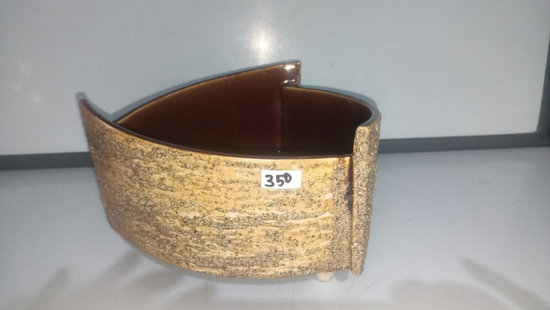Triangular Ikebana ceramic planter pot with three feet (Category: Pots & Planters) located in Munoz. Submitted by larryc1212 (Listing ID 1470633550, Image 1). Description: - Type: Triangular ceramic planter - Finish: Textured sandy exterior with glossy brown interior - Features: 3 sturdy feet for elevation - Size: Approx. 8 inchesacross the top, 5 incheshigh - Condition: Flawless, no chips or cracks - Ideal for: Succulents and small houseplants D