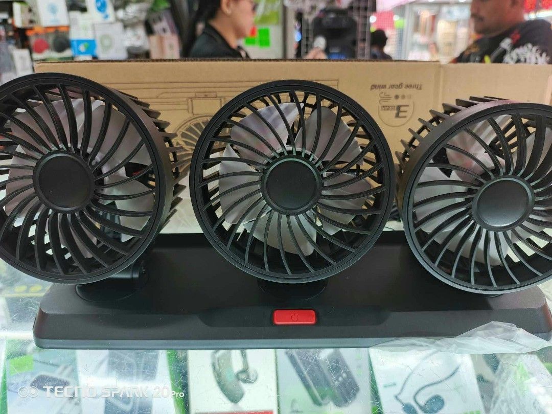 Triple Head USB Car Fan Three Gear Wind (Category: Fans) located in Manila. Submitted by ericklee23 (Listing ID 1470727622, Image 1). Description: - Type: Triple-head desktop fan - Design: Black plastic housing with white blades and a wide rectangular base - Control: Convenient red power button located in the center - Performance: 3 adjustable speed settings - Ideal Use: Perfect for cooling down office desks, study tables, or vehicle interiors ef