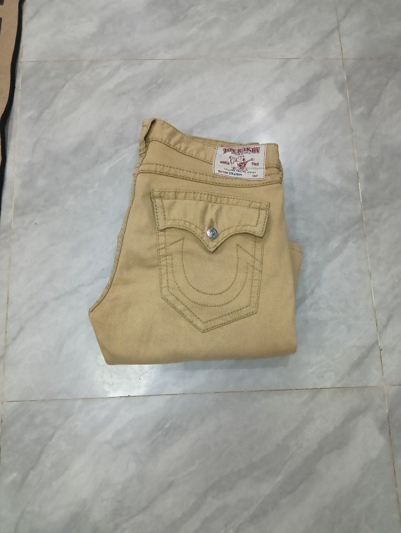 True Religion Straight Leg Jeans (Category: Jeans) located in Odiongan. Submitted by thrifthub_bundang07 (Listing ID 1470689517, Image 1). Description: - Brand: True Religion - Style: Straight leg fit - Color: Tan - Pockets: Classic button flap back pockets with iconic horseshoe stitching - Details: Branded leather patch on the back waistband and durable metal hardware throughout - Condition: Excellent pre-loved condition (ready to wear) - Mode o