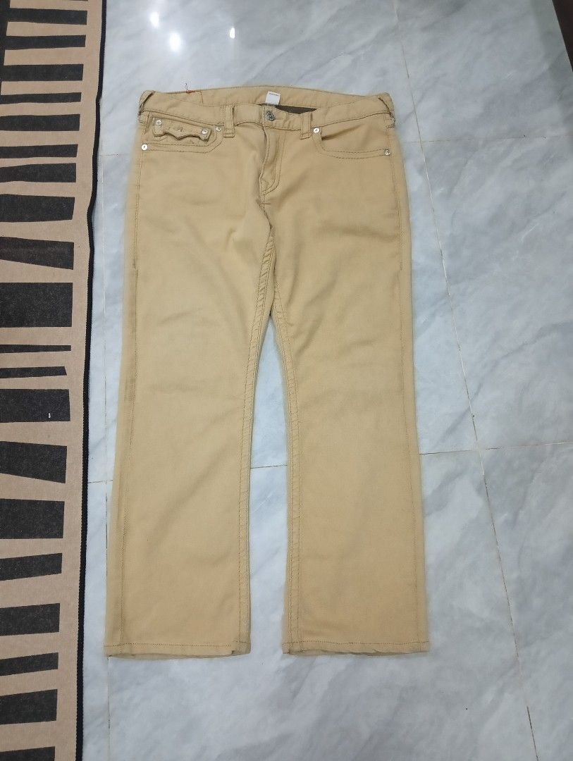 True Religion Straight Leg Jeans (Category: Jeans) located in Odiongan. Submitted by thrifthub_bundang07 (Listing ID 1470689517, Image 3). Description: - Brand: True Religion - Style: Straight leg fit - Color: Tan - Pockets: Classic button flap back pockets with iconic horseshoe stitching - Details: Branded leather patch on the back waistband and durable metal hardware throughout - Condition: Excellent pre-loved condition (ready to wear) - Mode o