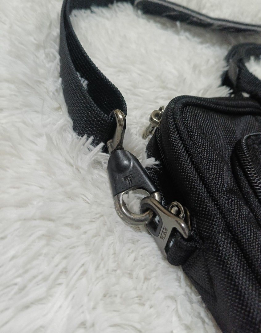 TUMI Black Laptop Briefcase Messenger Bag (Category: Briefcases) located in Quezon City. Submitted by lootsniwoah_12 (Listing ID 1470662602, Image 2). Description: - Brand: Tumi - Color: Black - Material: Durable high-quality nylon with sturdy metal zippers - Comfort: Includes a detachable shoulder strap with a comfortable padded guard - Storage: Multiple exterior zipped pockets for organizing chargers, documents, and essentials - Design: Slim pr