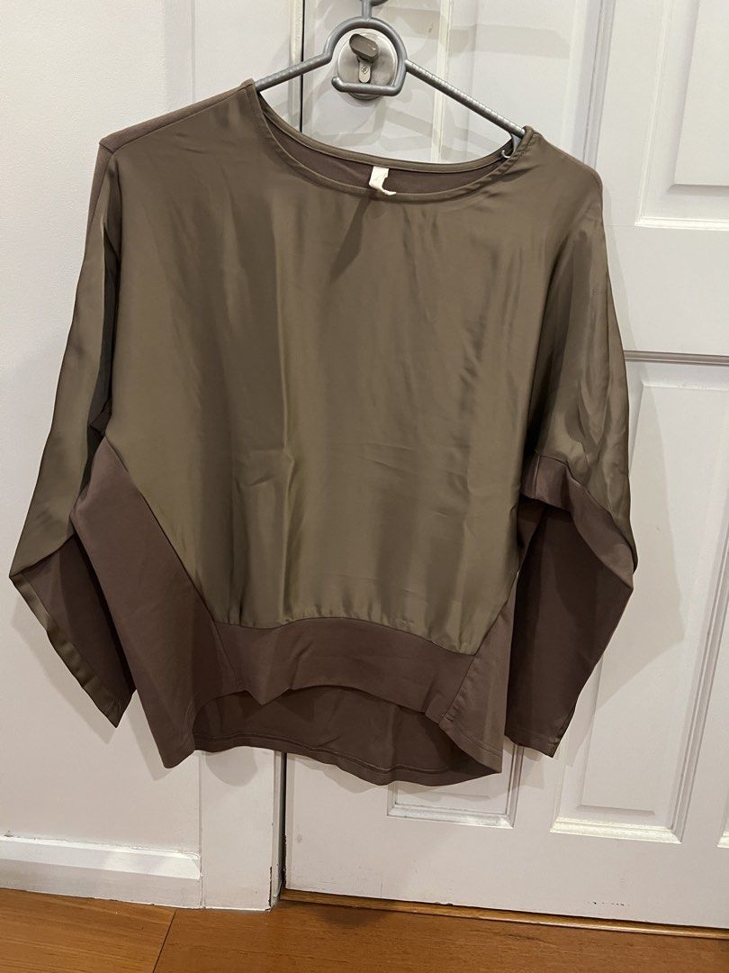 Two-tone Brown Long Sleeve Top Blouse (Category: Longsleeves) located in San Juan City. Submitted by thrillfinder (Listing ID 1470592765, Image 1). Description: - Color: Olive green front with dark brown contrast sides, hem, and sleeves - Fit: Relaxed batwing cut with a wide rounded neckline - Material: Smooth, silky texture on the main body - RFS: decluttering - MOP: Gcash - SF c/o buyer .