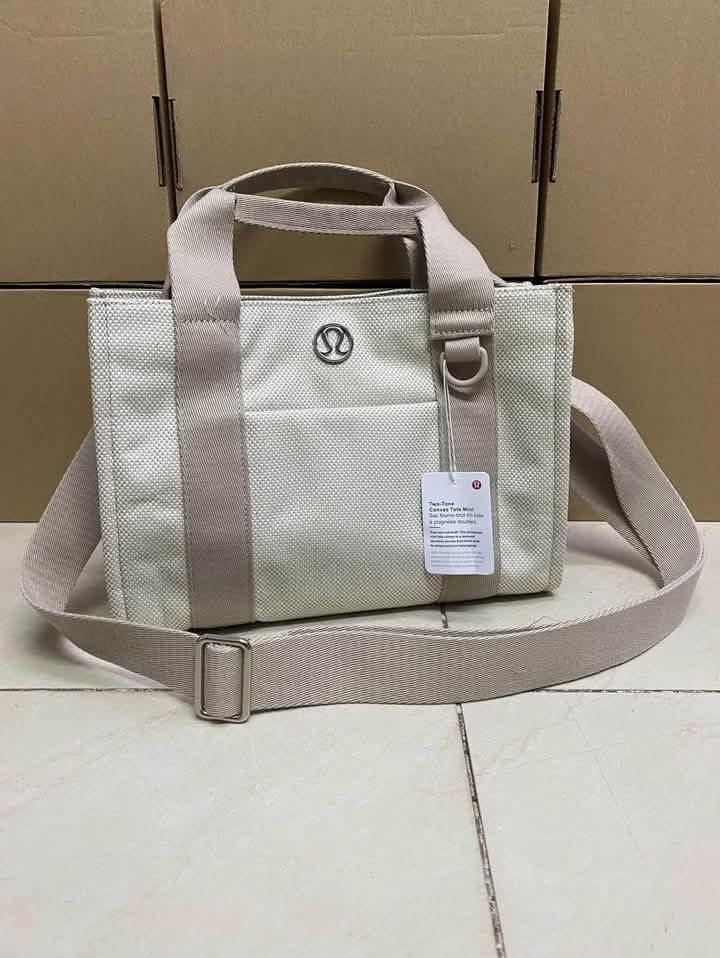 Two-Tone Canvas Tote Mini 27x20cm (Category: Tote Bags) located in Del Monte. Submitted by balanijoan70708 (Listing ID 1470686887, Image 2). Description: - Brand new with tag attached - Dimensions: 27 x 20 cm - Material: Sturdy, structured two-tone canvas - Dual top carry handles and matching adjustable/removable shoulder strap - Secure snap button closure - Convenient front slip pocket with circular metal logo.