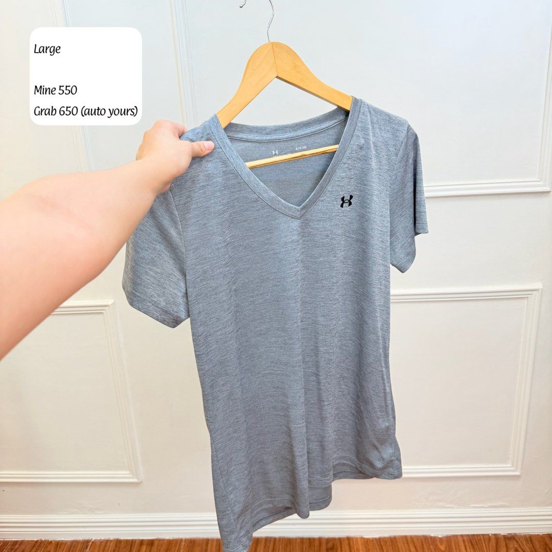 Under Armour Grey V-Neck Tee Large (Category: Tshirts & Polo Shirts ) located in Manila. Submitted by angelll0123 (Listing ID 1470707025, Image 1). Description: - Brand: Under Armour - Size: Large - Color: Grey marled - Style: V-neck, short sleeves - Logo: Small black embroidered logo on left chest - Material: Lightweight athletic fabric - Condition: Excellent - Perfect for gym workouts, sports, or casual everyday wear.