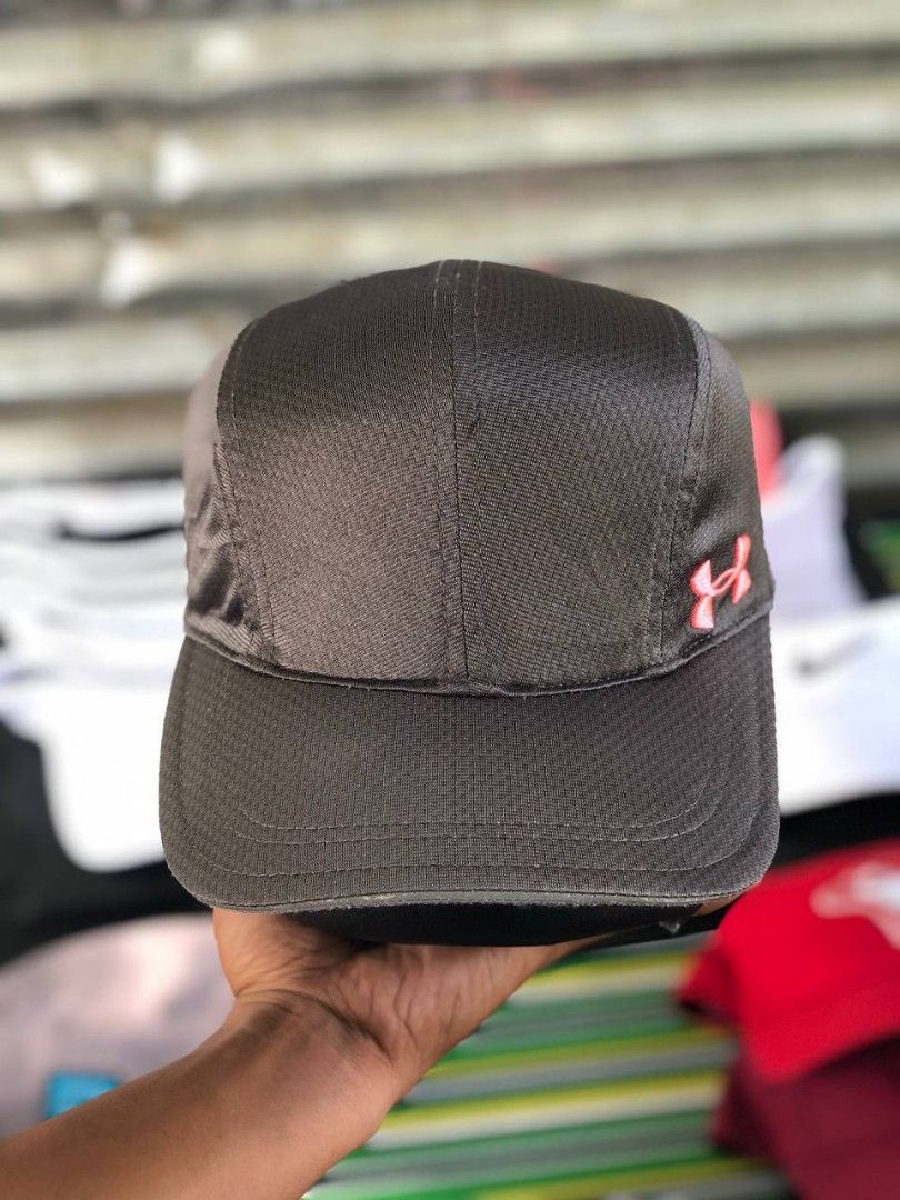 Under Armour Women's Run Cap Grey OSFA (Category: Activewear) located in Manila. Submitted by jowiegarci63146 (Listing ID 1470562261, Image 2). Description: - Brand: Under Armour - Color: Grey with pink side logo - Size: Women's OSFA (One Size Fits All) - Material/Design: Breathable mesh panels inside for ventilation - Strap: Adjustable back strap with Under Armour logo tape - Sweatband: Interior band with repeating 'Run' graphics - Condition: Ex