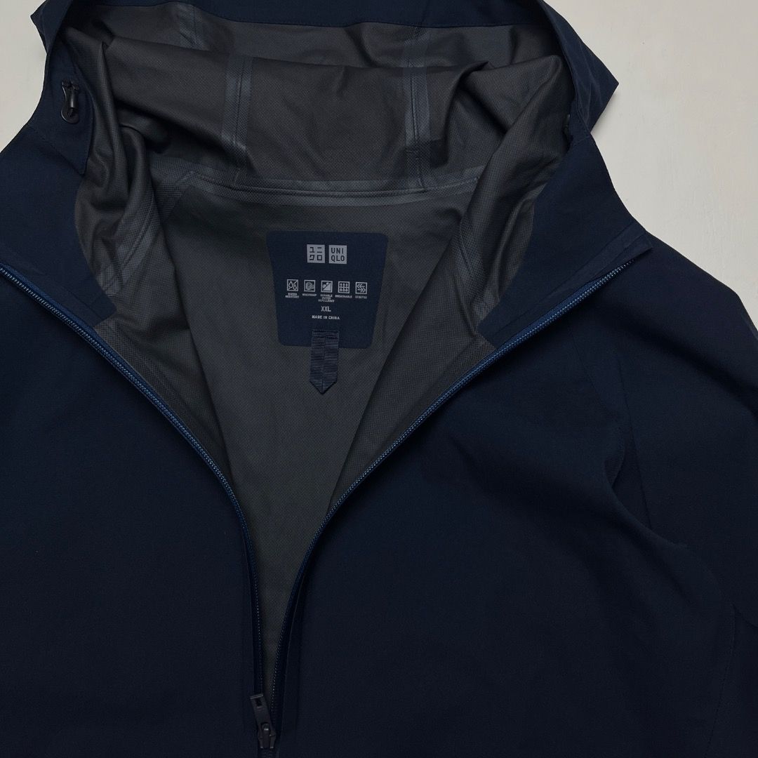 Uniqlo Blocktech Waterproof Jacket (Category: Coats, Jackets and Outerwear) located in Caloocan City. Submitted by achilles_grails (Listing ID 1470564811, Image 2). Description: - Brand: Uniqlo - Color: Navy - Size: XL - Material: 100% polyester with recycled polyester fiber blend - Closure: Full front zipper - Features: Weather-resistant fabric, clean interior lining, printed neck label, and detailed care tag - Best for: Rainy days and outdoor a