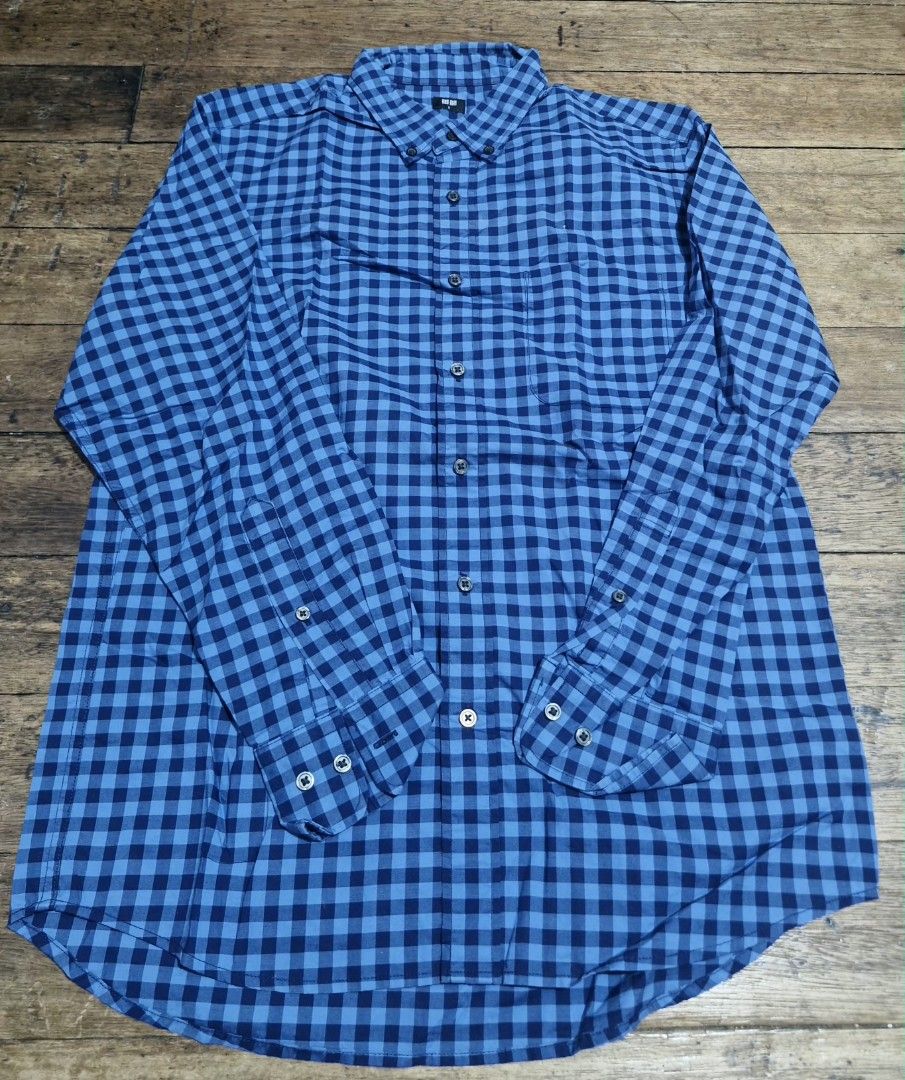 Uniqlo Blue Checkered Long Sleeve Button Down Shirt (Category: Longsleeves) located in Manila. Submitted by blackstarharpoon (Listing ID 1470584351, Image 1). Description: - Brand: Uniqlo - Style: Long sleeve button-down shirt - Pattern: Blue and dark blue checkered - Details: Single left chest pocket, standard collar, adjustable button cuffs - Material: Lightweight and breathable - Condition: Clean and ready to wear unisex.