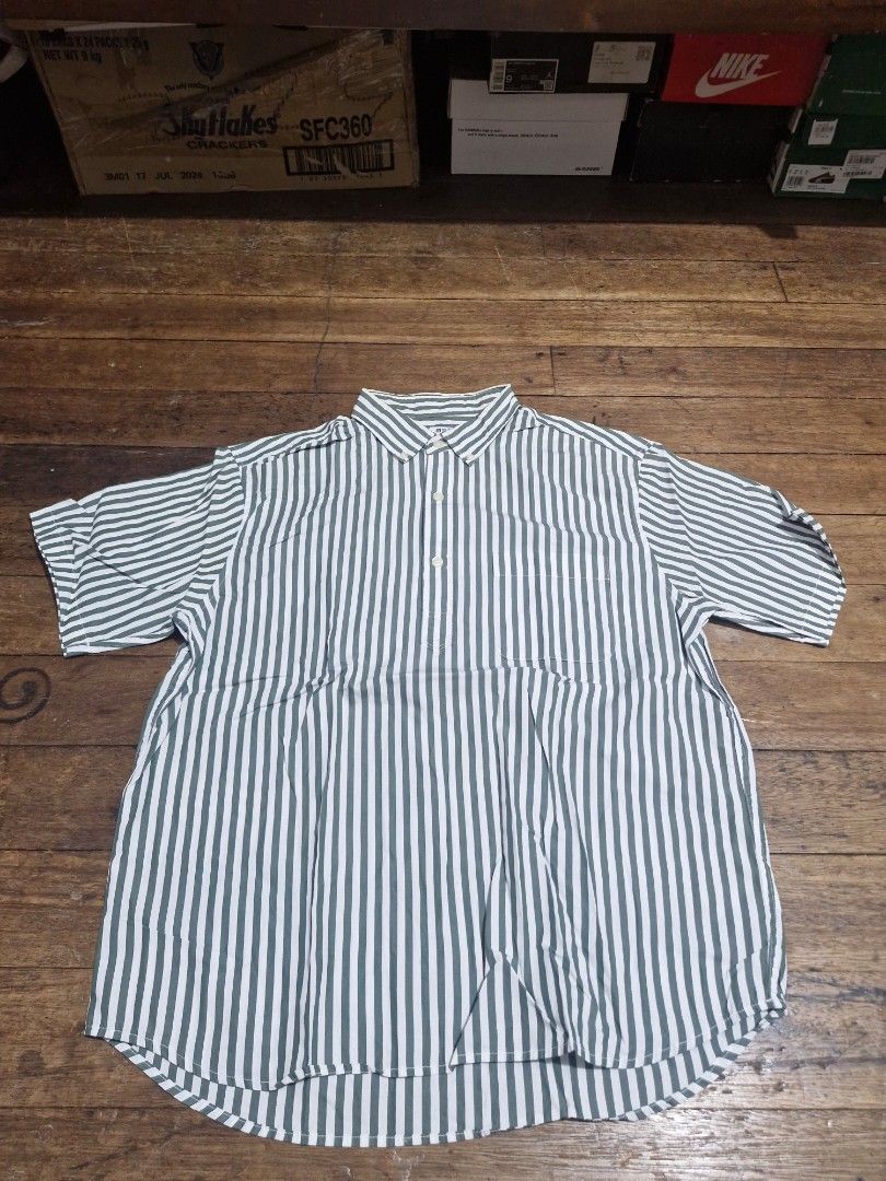 Uniqlo button down shirt (Category: Shirts) located in Manila. Submitted by blackstarharpoon (Listing ID 1470582762, Image 1). Description: - Color/Pattern: Green and white stripes - Sleeve: Short sleeve - Details: Regular collar, single left chest pocket - Fabric: Lightweight (great for casual wear or layering) need wash, washable stain unisex.