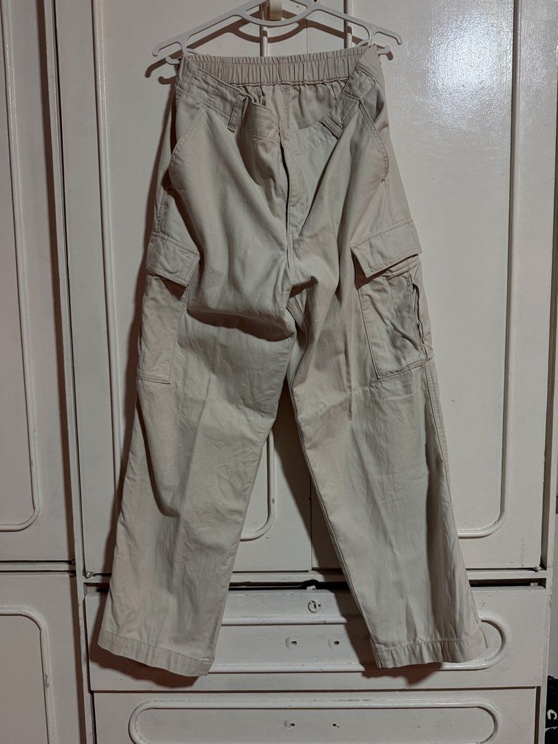 Uniqlo Cargo Pants in Beige (Category: Other Bottoms) located in Quezon City. Submitted by celinecabrera (Listing ID 1470719937, Image 1). Description: - Features: Elastic waistband with button closure, belt loops, and multiple side and back cargo pockets - Fits waist 33-34.