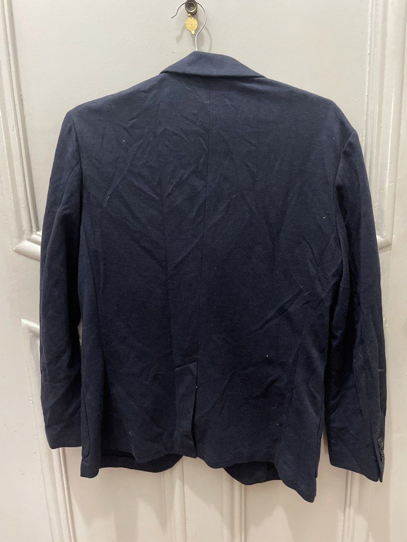 Uniqlo Navy Blue Casual Blazer Jacket (Category: Coats, Jackets and Outerwear) located in Cainta. Submitted by nancygoreng (Listing ID 1470616739, Image 3). Description: - Brand: Uniqlo - Color: Navy blue - Material: Cotton jersey knit with comfortable stretch - Measurements: 16.5 inches between shoulder seams, 26 inches top to bottom, 22 inches sleeves, shoulder to wrist - Design: Two-button closure, standard lapel, patch pockets at the waist, a
