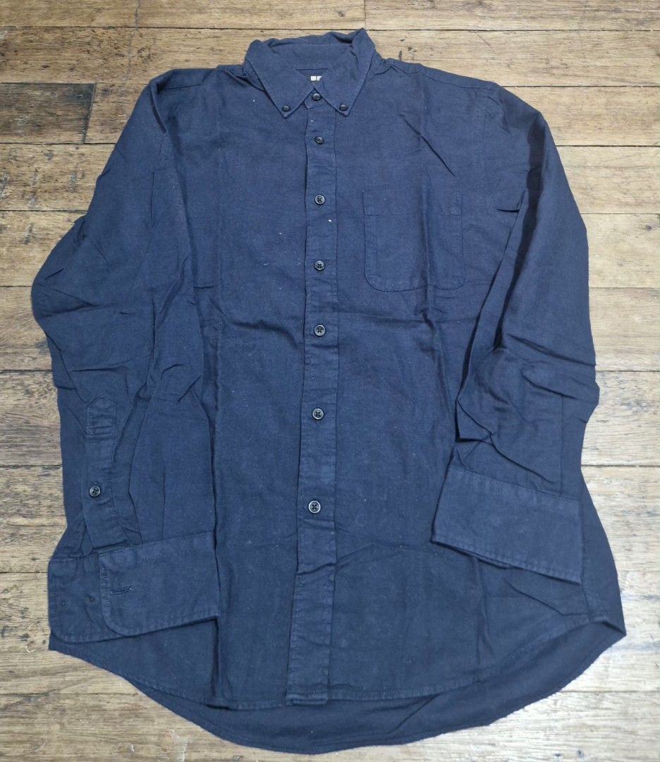 Uniqlo Navy Blue Long Sleeve Button-Down Shirt (Category: Longsleeves) located in Manila. Submitted by blackstarharpoon (Listing ID 1470583321, Image 1). Description: - Brand: Uniqlo - Color: Dark blue - Style: Long sleeve button-down shirt with standard collar - Features: Single left chest pocket, adjustable button cuffs, and rounded hemline - Material: Soft cotton/linen blend - Condition: Excellent, clean look - Perfect for: Casual days, office
