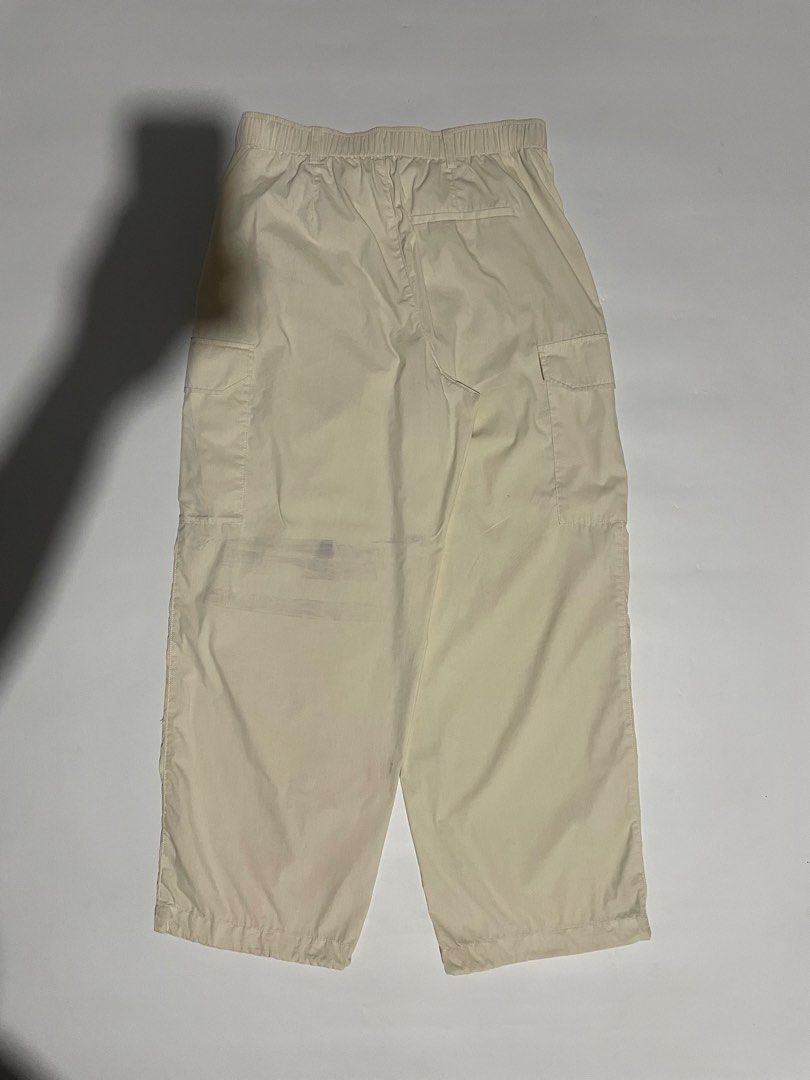 Uniqlo parachute cargo pants (Category: Trousers) located in Bais. Submitted by christian.complexthrift08 (Listing ID 1470649739, Image 2). Description: Uniqlo parachute cargo pants (Perfect for daily use) Color: off white Size: 30 to 32 on tape Length: 39 inches Thigh: 14 inches Leg opening: 9.7 inches Condition: 9 / 10 Issue: blue stain Price: 399 free shipping Meet up or via JNT express.