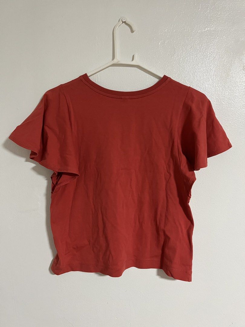 Uniqlo Red Flutter Sleeve Tee (Category: Shirts) located in Cabuyao City. Submitted by rdtrmt (Listing ID 1470576808, Image 3). Description: - Brand: Uniqlo - Color: Red - Size: S - Material: Soft cotton blend (Made in Vietnam) - Design: Short flutter sleeves and classic crew neckline - Style Tip: Great basic piece to match with high-waisted jeans or skirts - Condition: still in good condition .